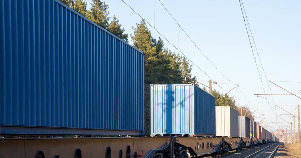 A line of intermodal containers along a railway.
