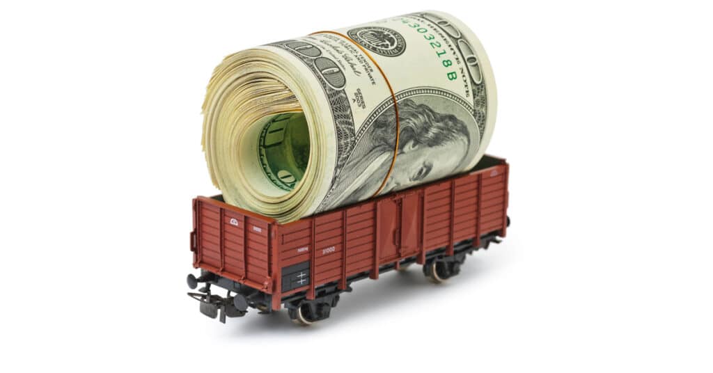 A railcar with a roll of united states hundred dollar bills inside.