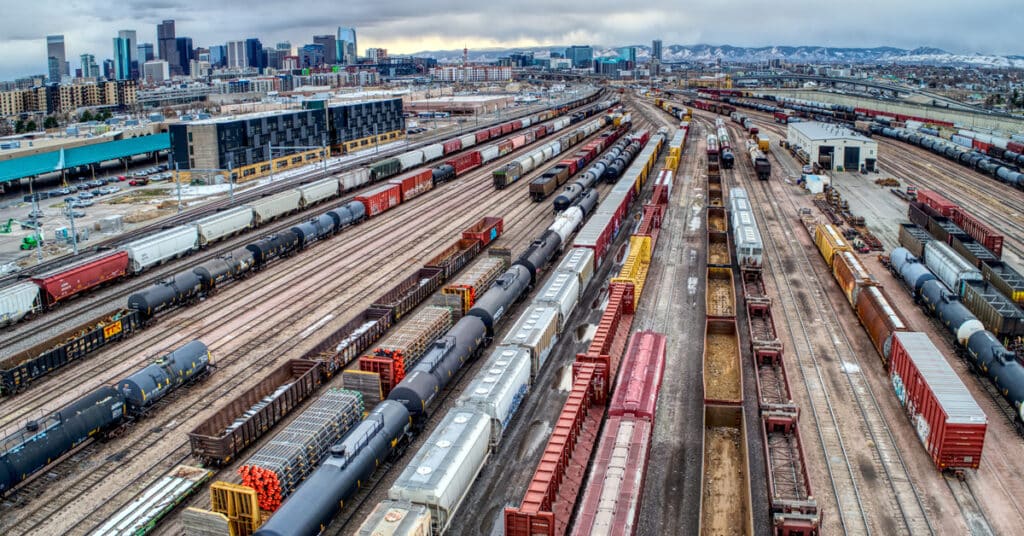 An aerial view of a railcar switching yard outside the city skyline of Chicago.