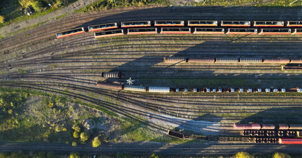 A top down view of a railyard with lines of various rail cars.