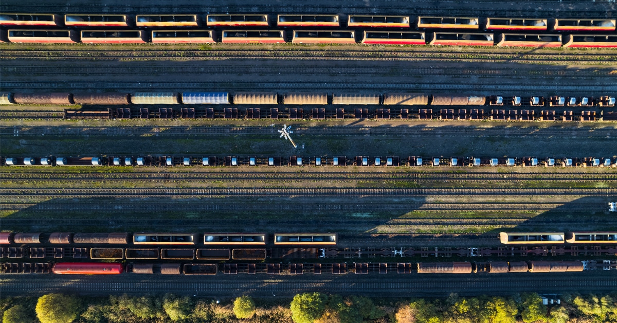 Lines of rail freight are lined up in a rail freight yard.
